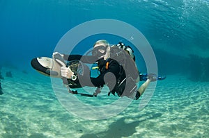 Female diver on underwater scooter