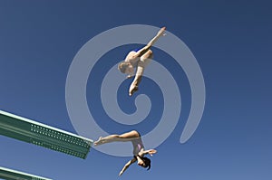 Female Divers Diving In Midair photo