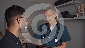 Female doctor assisting patient in clinic