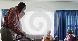 Female doctor assisting senior man to walk with folding walkers 4k