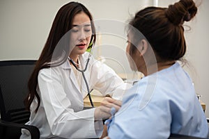 Female doctor cardiologist examining fat woman cardiac patient listening checking heartbeat using stethoscope