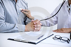 Female doctor checking heart beat of patient and recommend treat