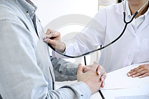 Female doctor checking heart beat of patient and recommend treat