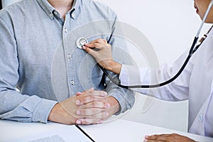 Female doctor checking heart beat of patient and recommend treat