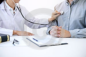 Female doctor checking heart beat of patient and recommend treat