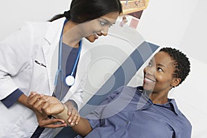 Female Doctor Checking Patient's Pulse