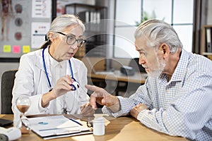 Female doctor checking pulse and saturation to senior man