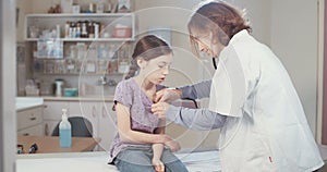 Female doctor checking a sick young girl