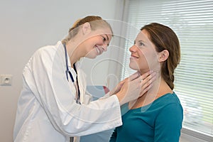 Female doctor checking throat young patient