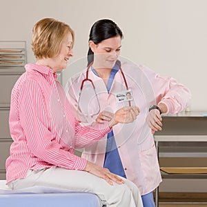 Female doctor checking womans pulse during check