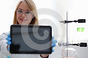 A female doctor in a chemical laboratory holds