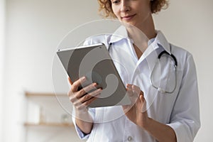 Female doctor consult client on tablet gadget