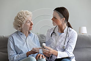 Female doctor consult senior patient about medicine prescription