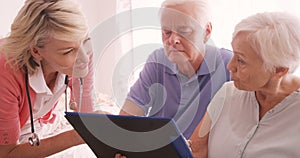 Female doctor consulting to a senior couple