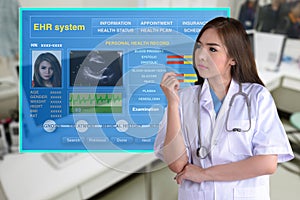 Female doctor and display of electronic health record system.