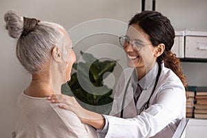 Female doctor encourage unhealthy senior lady at appointment in hospital