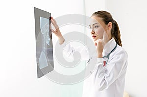 Female doctor examines the results of the X-ray.