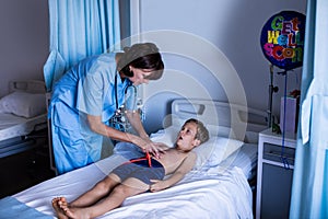 Female doctor examining abdomen of patient