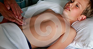 Female doctor examining abdomen of patient