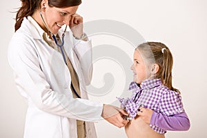 Female doctor examining child with stetoscope