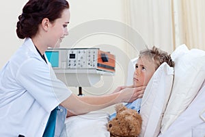 Female doctor examining child throat