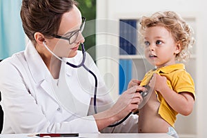 Female doctor examining little sweet boy