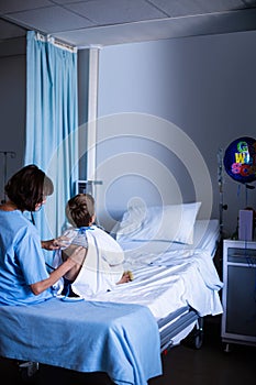 Female doctor examining patient with stethoscope