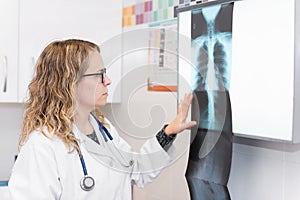 Female doctor examining radiography in the hospital