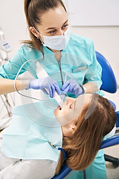 Female doctor examining woman teeth with dental 3D scanner