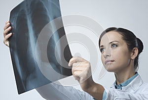 Female doctor examining x-ray image