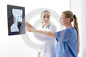 Female doctor explained the results of the X-ray examination.Female doctor examines the results of the X-ray.