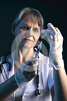 Female doctor filling a syringe