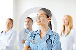 Female doctor in front of medical group