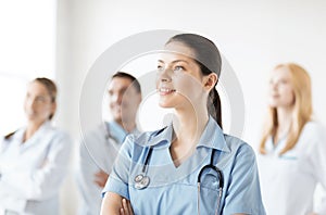 Female doctor in front of medical group