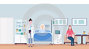 Female doctor and girl visiting patient senior woman lying bed intensive therapy ward healthcare concept hospital room