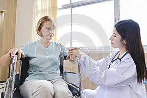 Female doctor gives advice and encourages the old woman patient