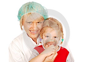 Female doctor gives the child inhalation