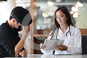 Female doctor giving advice and explaining treatment to her patient.