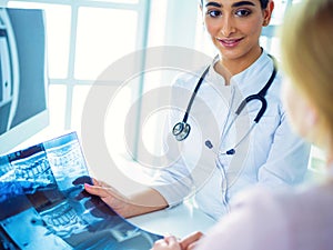 Female doctor giving a consultation to a patient and explaining medical informations and diagnosis