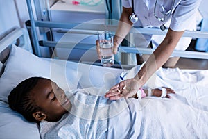 Female doctor giving medicine to patient