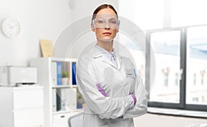 female doctor in goggles and gloves at hospital