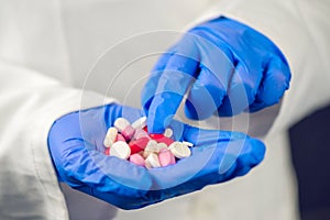 Female doctor hand full of various pills and medications