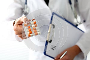 Female doctor hand hold prescription on clipboard pad