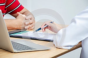Female doctor hand hold silver pen filling patient history list at clipboard pad, Patient listening receiving in medical clinic