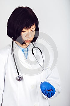 Female doctor hand holding black-red capsules