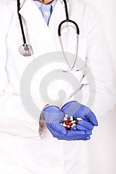 Female doctor hand holding  many different pills