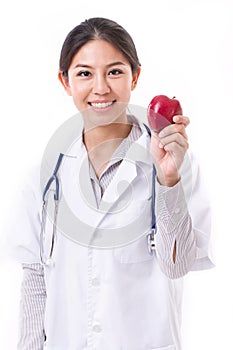 Female doctor with hand holding red apple