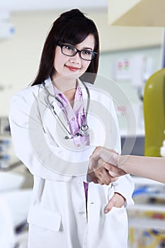 Female doctor handshaking