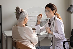 Female doctor have consultation with senior patient