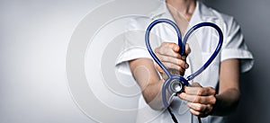 Female doctor with heart shaped stethoscope. healthcare job love, cardiology or health insurance concept. copy space